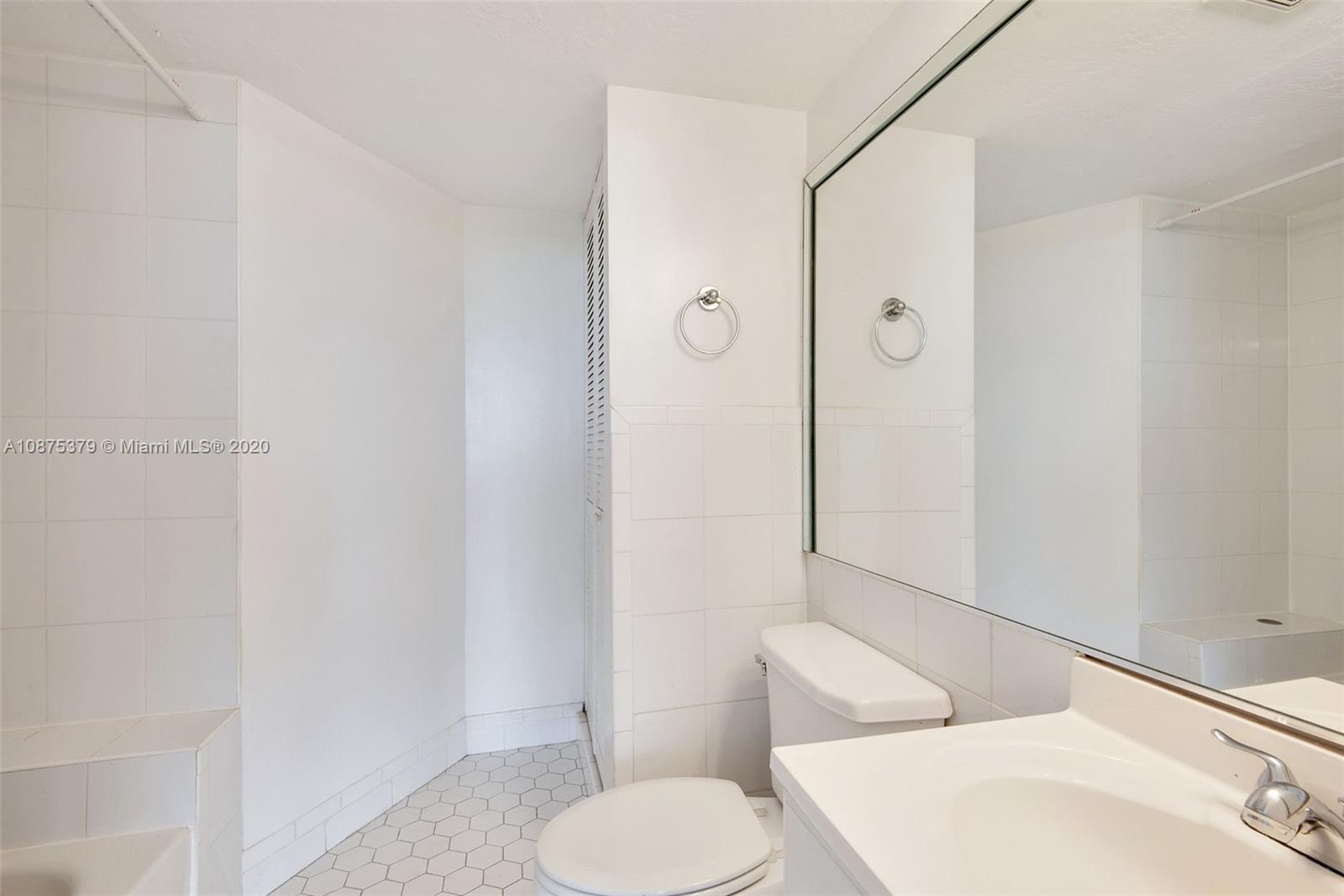 Morningside Miami, FL 33137 - Photo 18 of 27 a white toilet sitting next to a bathroom sink