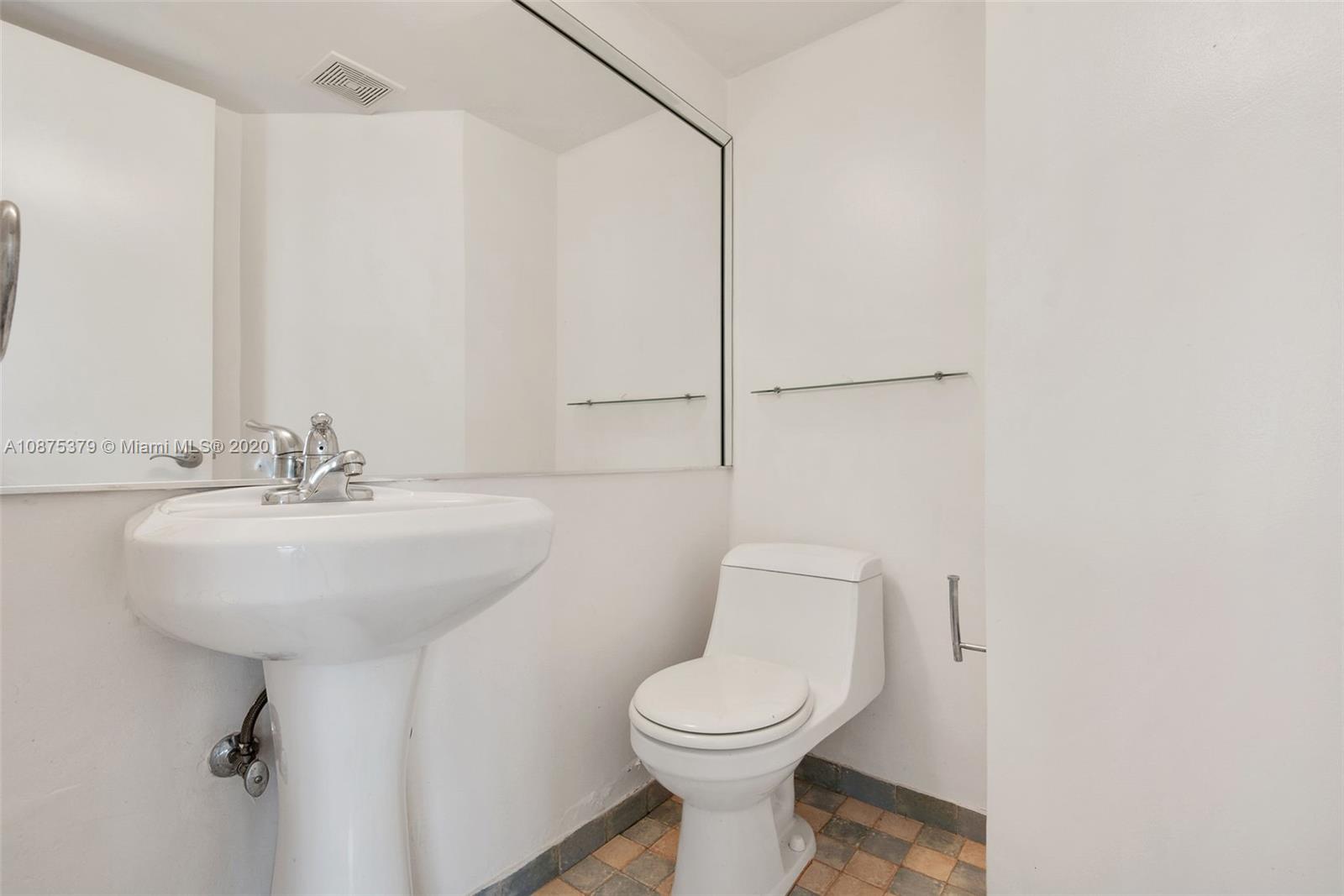 Morningside Miami, FL 33137 - Photo 21 of 27 a bathroom with a toilet sink and mirror