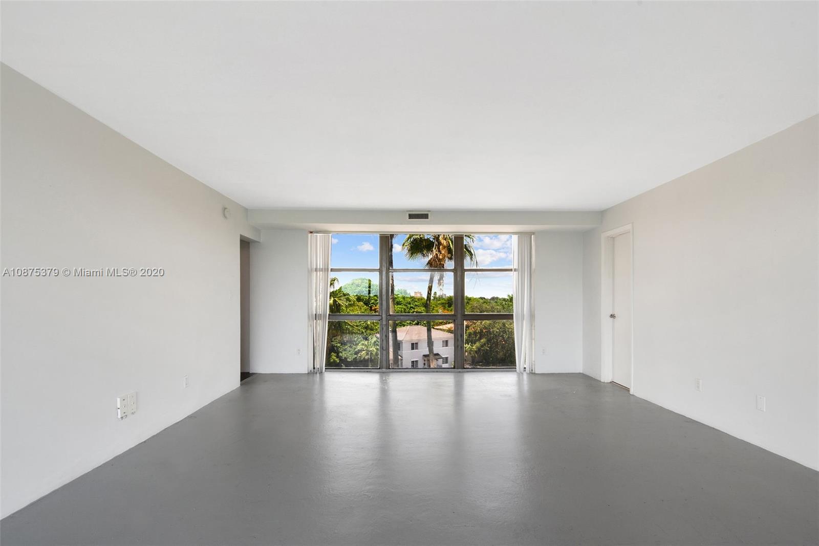Morningside Miami, FL 33137 - Photo 8 of 27 a view of an empty room with window and wooden floor