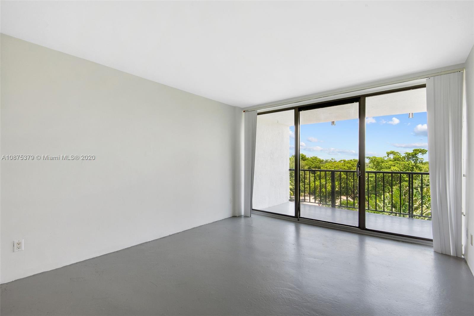 Morningside Miami, FL 33137 - Photo 9 of 27 an empty room with wooden floor and sliding door