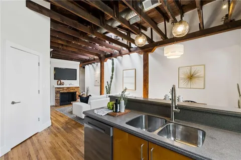 a kitchen with stainless steel appliances a sink a stove and cabinets