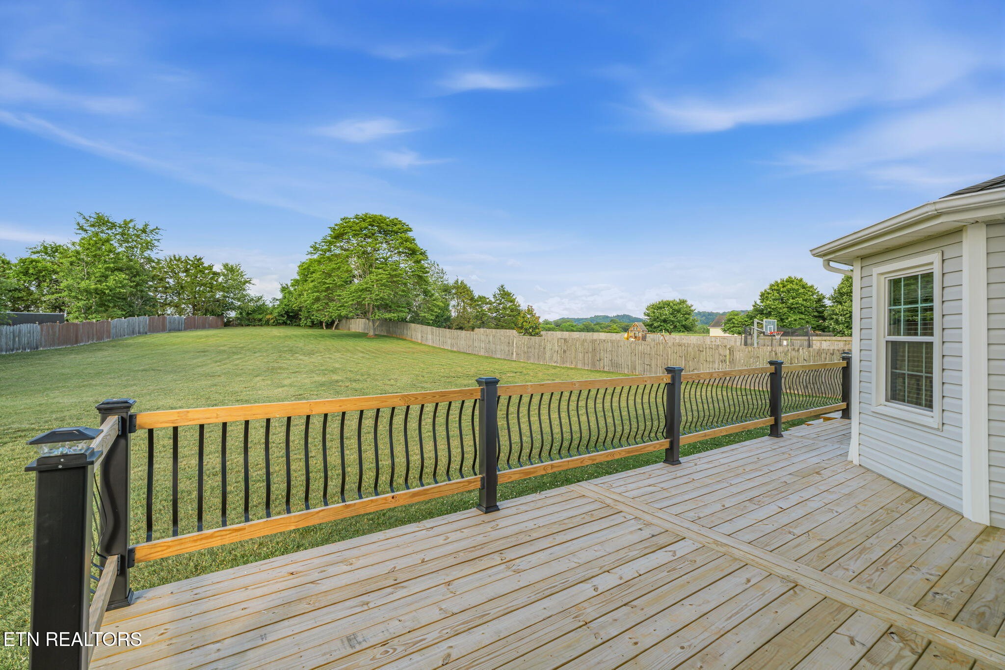 7030 Westerly Winds Road Knoxville, TN 37931 - Photo 35 of 40 a view of a wooden deck with a yard