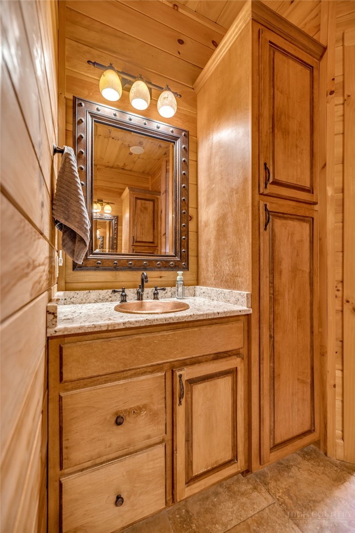 7994 3 Top Road Todd, NC 28684 - Photo 19 of 50 a bathroom with a granite countertop sink a mirror and a shower