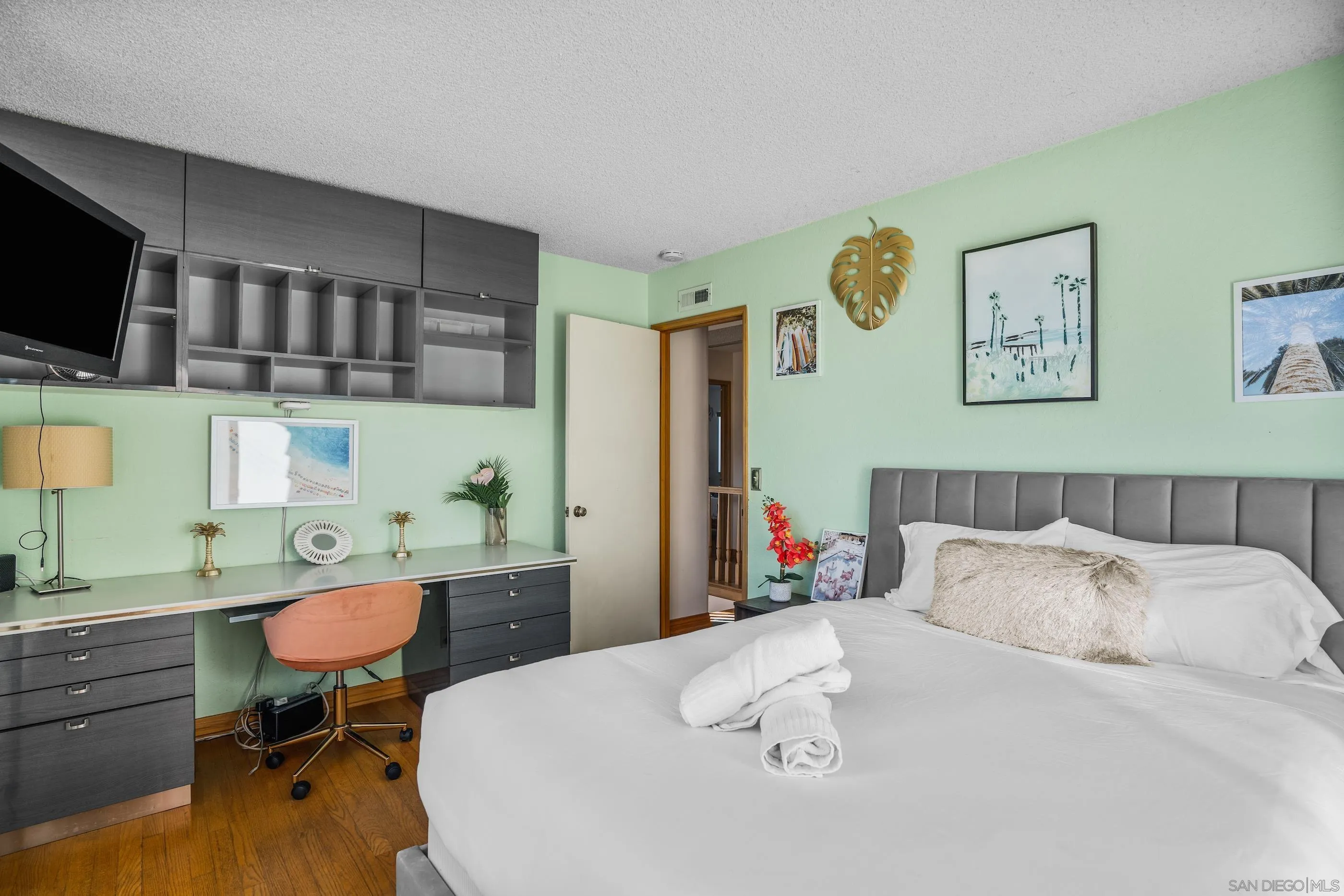 1530 Vanessa Circle Encinitas, CA 92024 - Photo 26 of 45 a bed room with a bed a television couches and a flat tv screen