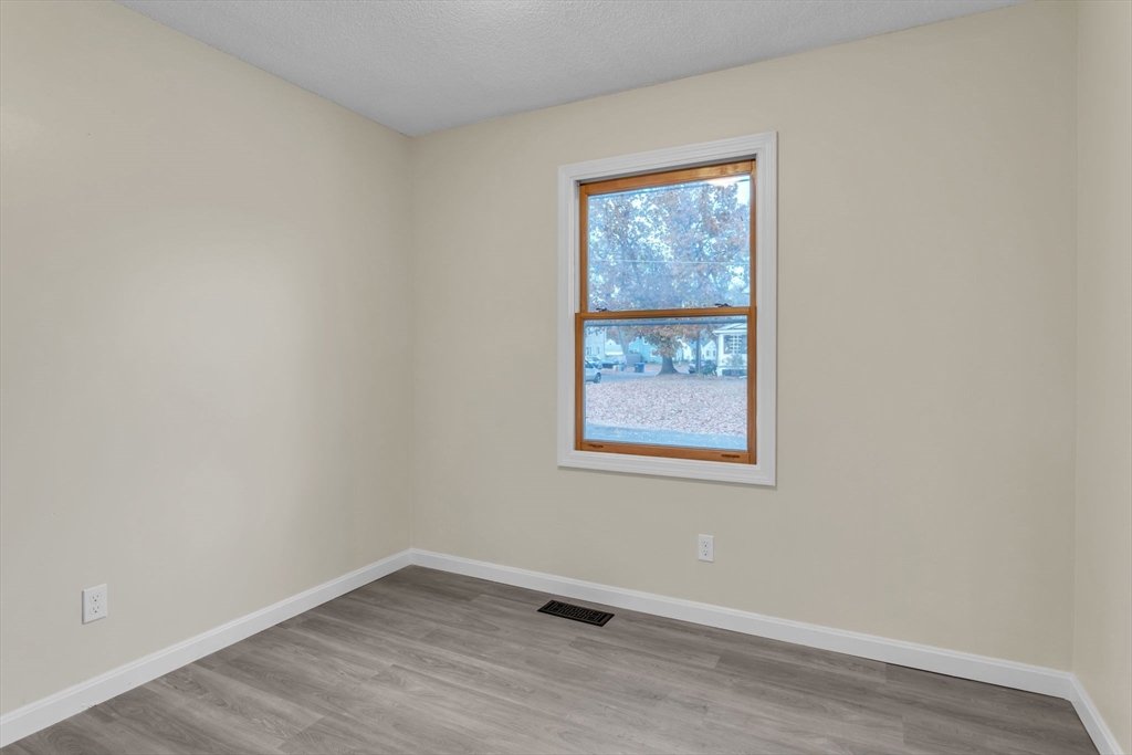 115 Carroll Street Springfield, MA 01108 - Photo 12 of 25 an empty room with a window
