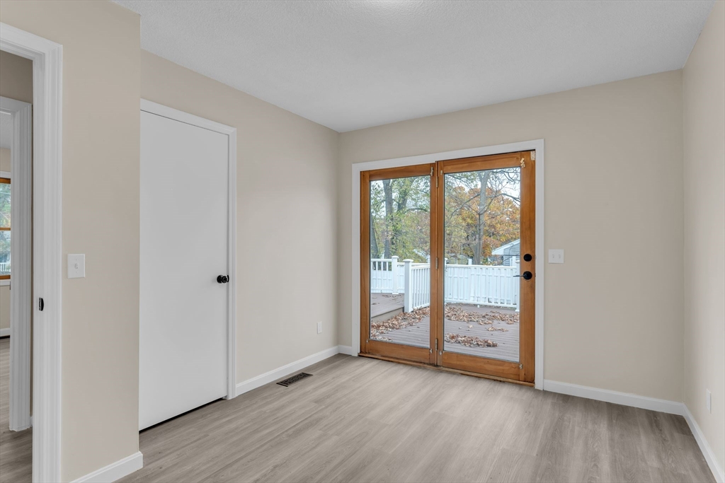 115 Carroll Street Springfield, MA 01108 - Photo 17 of 25 a view of an empty room with wooden floor and a window