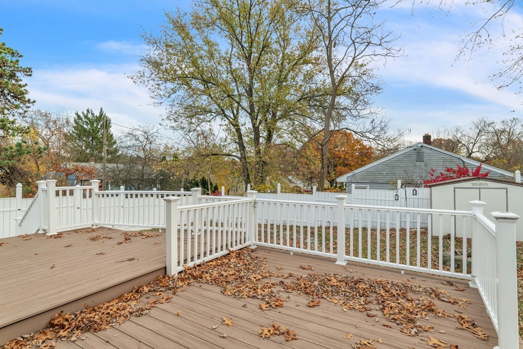 115 Carroll Street Springfield, MA 01108 - Photo 22 of 25 a view of a brick house with wooden floor and fence next to a yard