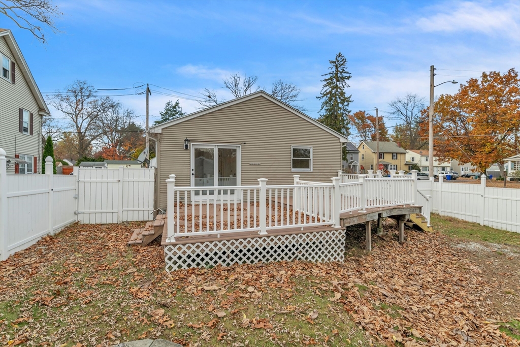 115 Carroll Street Springfield, MA 01108 - Photo 23 of 25 a view of a house with a small yard and wooden fence