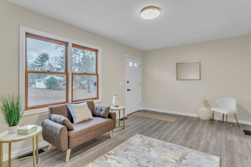 115 Carroll Street Springfield, MA 01108 - Photo 6 of 25 a living room with furniture and a large window