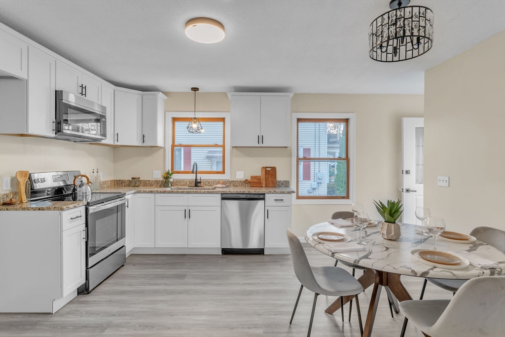 115 Carroll Street Springfield, MA 01108 - Photo 9 of 25 a kitchen with a table and chairs in it