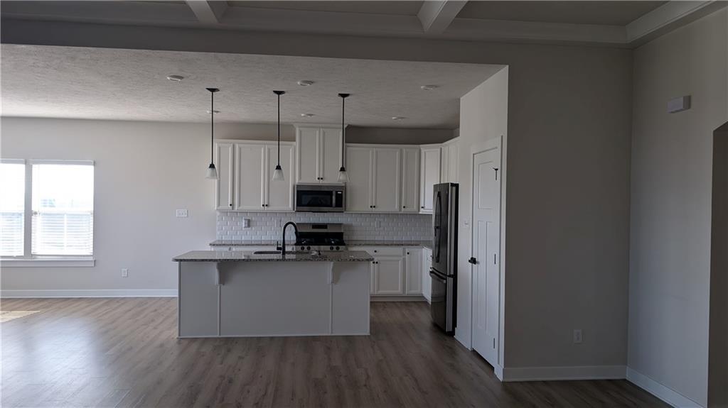 170 High Pointe Drive Washington, PA 15301 - Photo 5 of 29 a kitchen with stainless steel appliances a refrigerator a sink dishwasher a stove and white cabinets with wooden floor