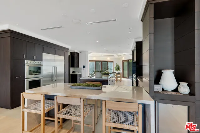 a kitchen with stainless steel appliances granite countertop a stove and a refrigerator