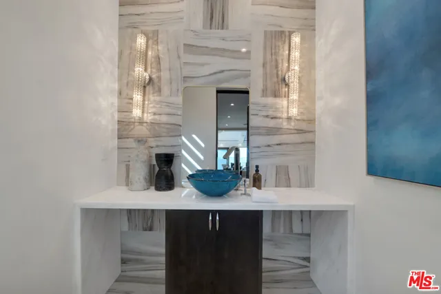 a living room with furniture kitchen view and a large window