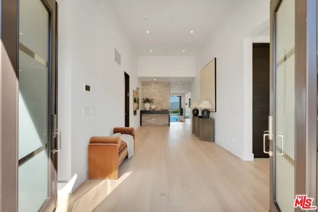 a view of a living room with furniture and a large window