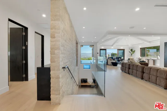 a large bedroom with a large bed and a balcony