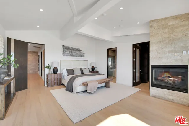 a bathroom with a double vanity sink a toilet a mirror and bathtub