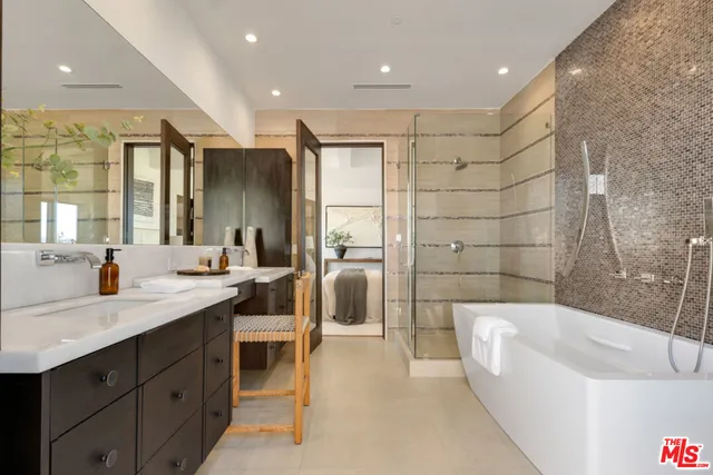 a bathroom with a sink a toilet a mirror and shower