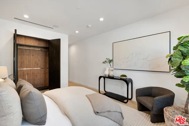 a living room with furniture potted plant and a large window
