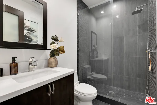 a large white kitchen with a large counter top furniture and a wooden floor