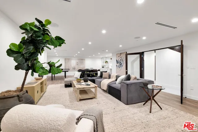 a living room with furniture and a floor to ceiling window