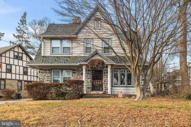 a front view of a house with a yard covered in snow