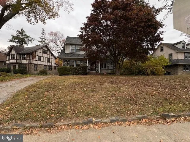 a view of a house with a large tree