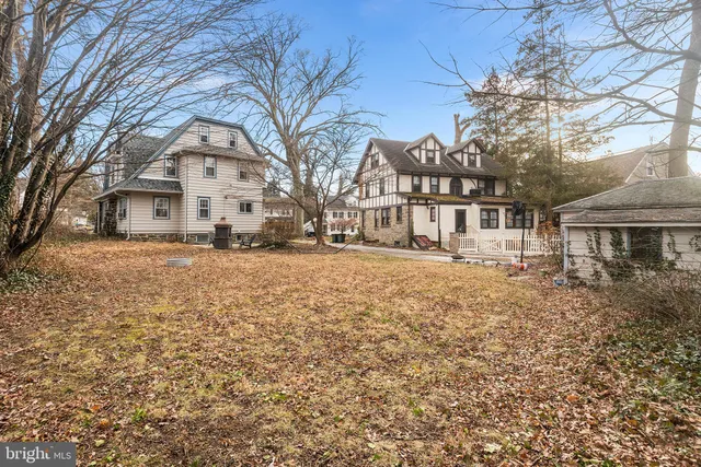 a view of a white house with a yard covered with snow