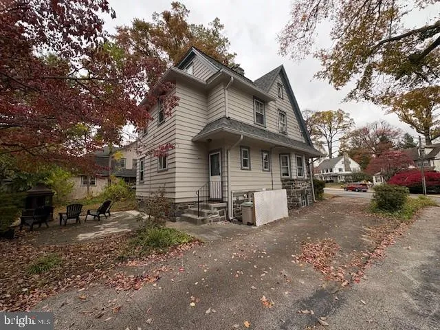 a view of a house with a yard and sitting area