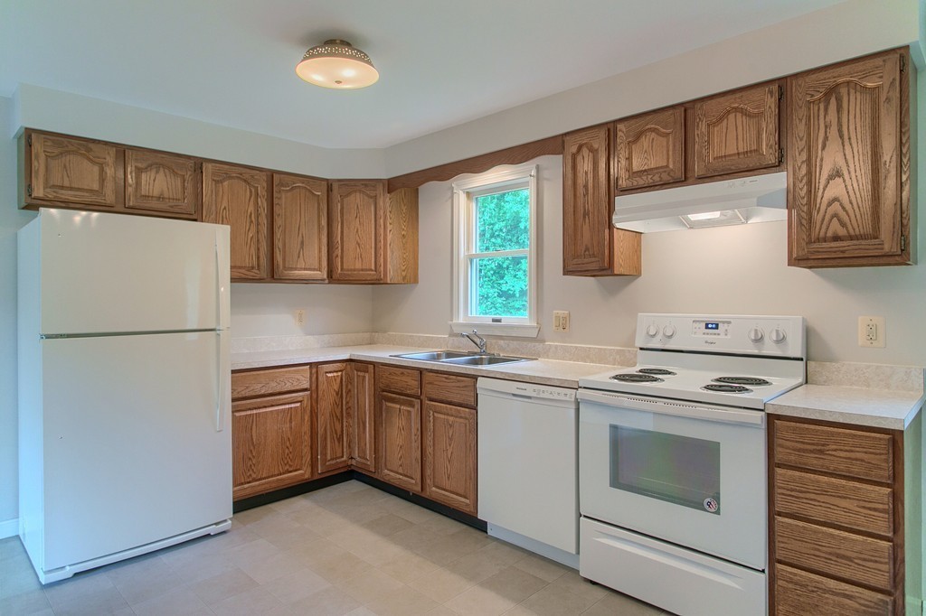 16 Clement Road Townsend, MA 01474 - Photo 5 of 19 a kitchen with a stove sink and refrigerator