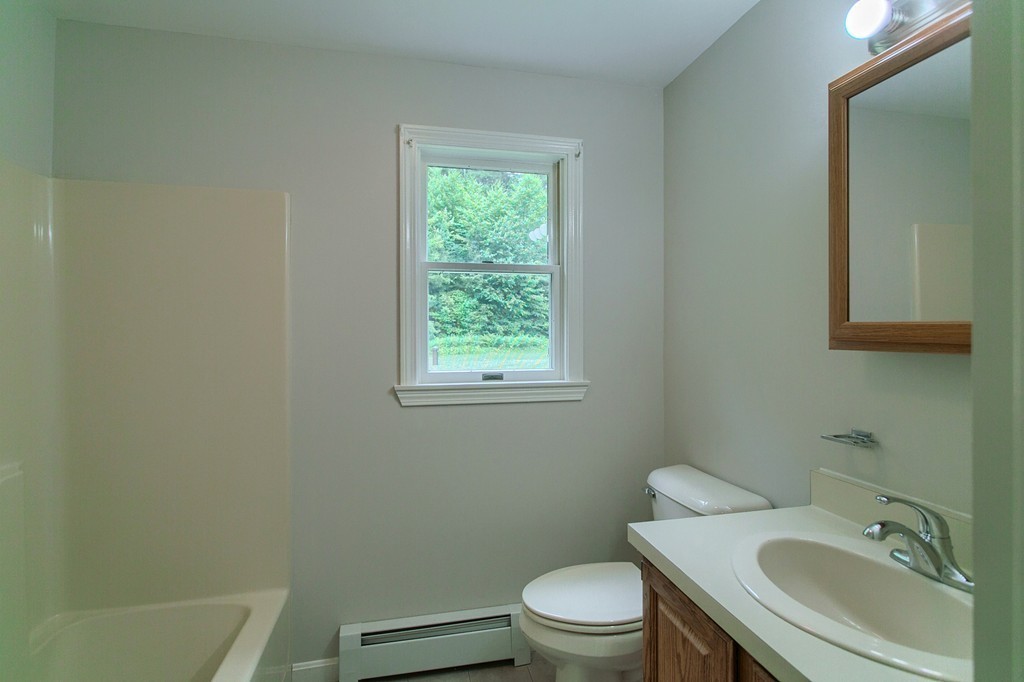 16 Clement Road Townsend, MA 01474 - Photo 9 of 19 a bathroom with a sink toilet and a mirror