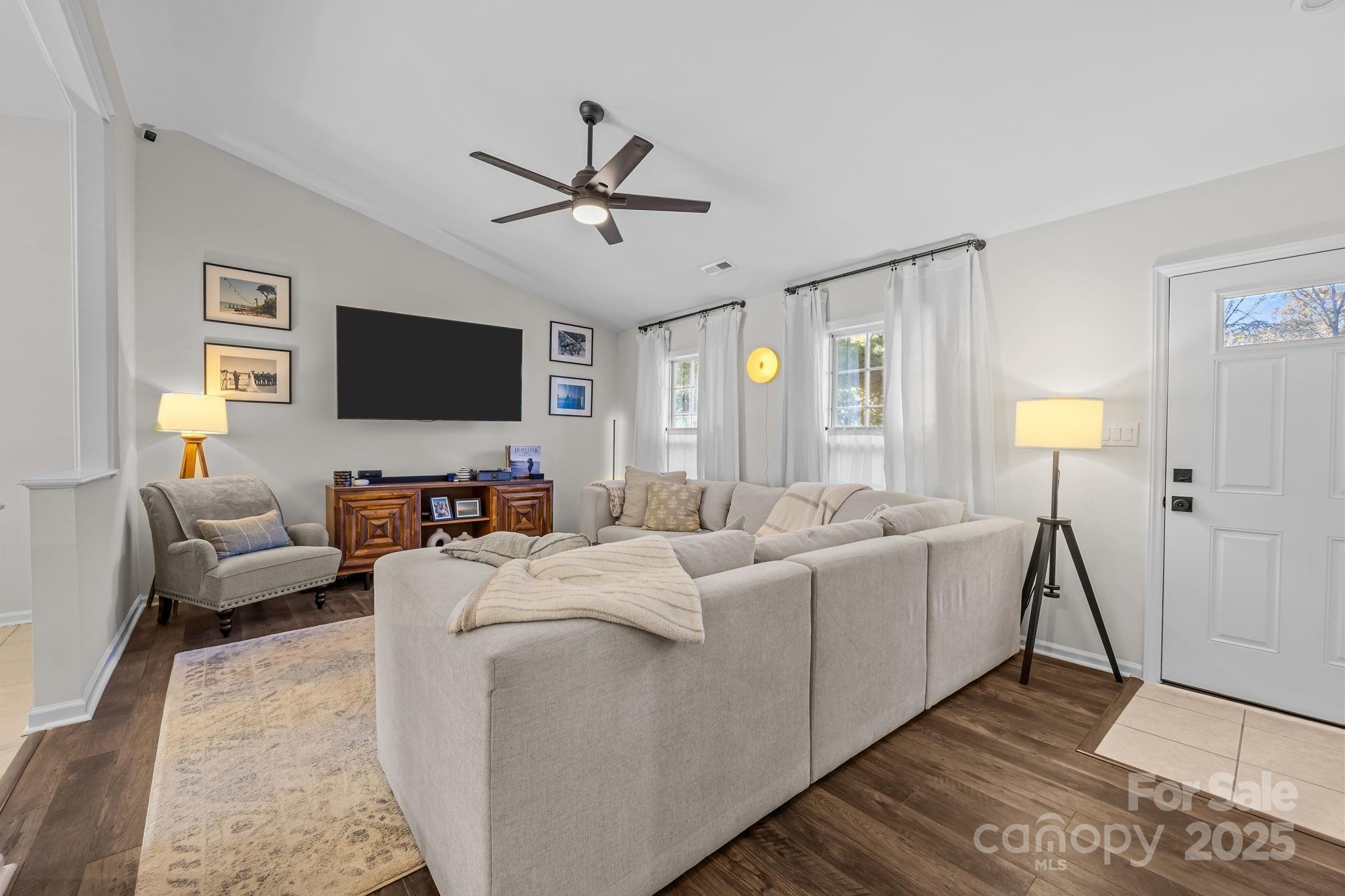 3512 Cross Winds Road Charlotte, NC 28227 - Photo 3 of 32 a living room with a couch and a flat screen tv