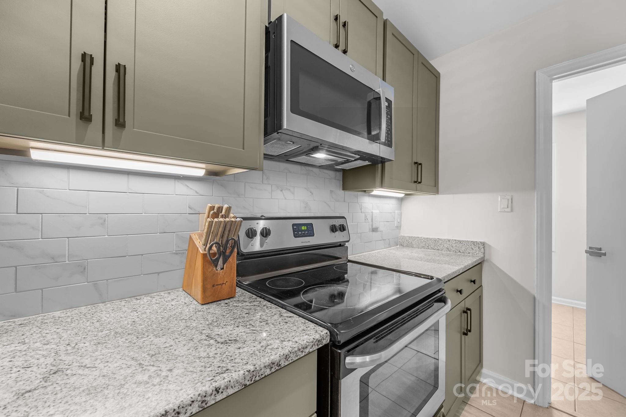 3512 Cross Winds Road Charlotte, NC 28227 - Photo 7 of 32 a kitchen with a stove and a microwave