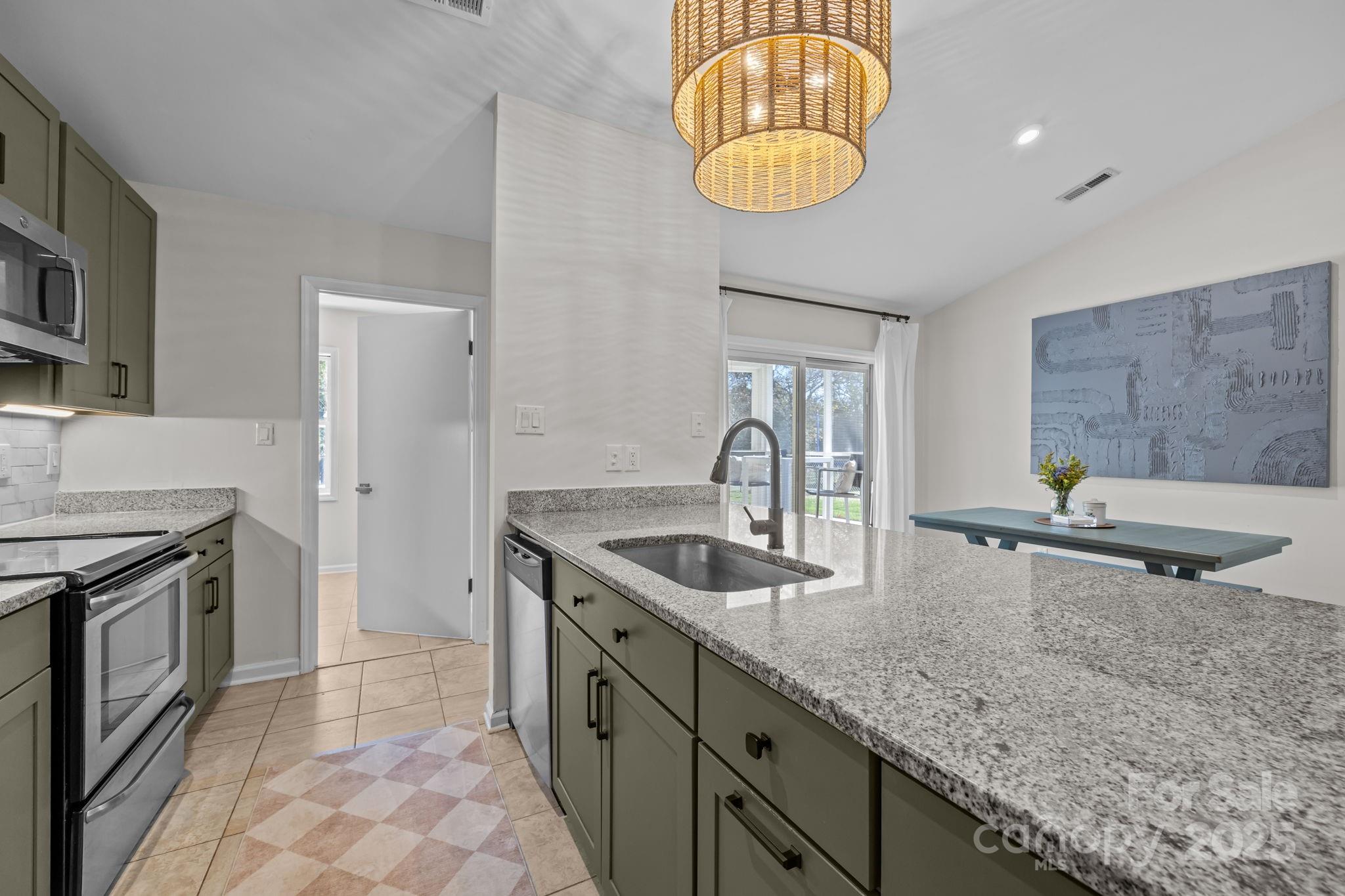 3512 Cross Winds Road Charlotte, NC 28227 - Photo 8 of 32 a kitchen with stainless steel appliances granite countertop a sink a stove counter space and cabinets