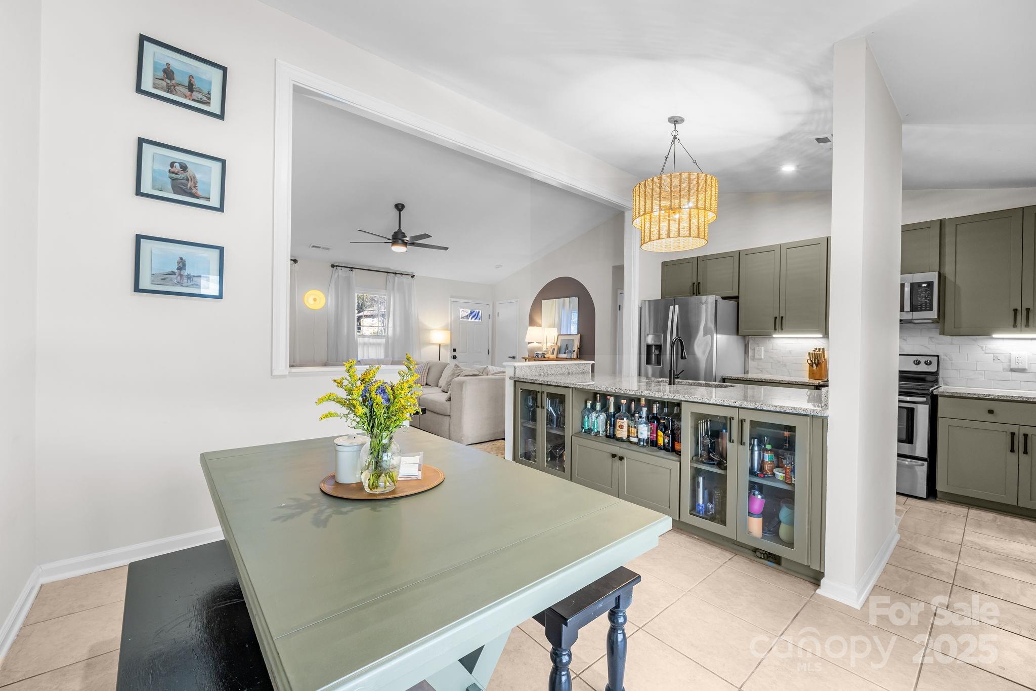 3512 Cross Winds Road Charlotte, NC 28227 - Photo 9 of 32 a kitchen with stainless steel appliances a dining table a stove top oven and sink