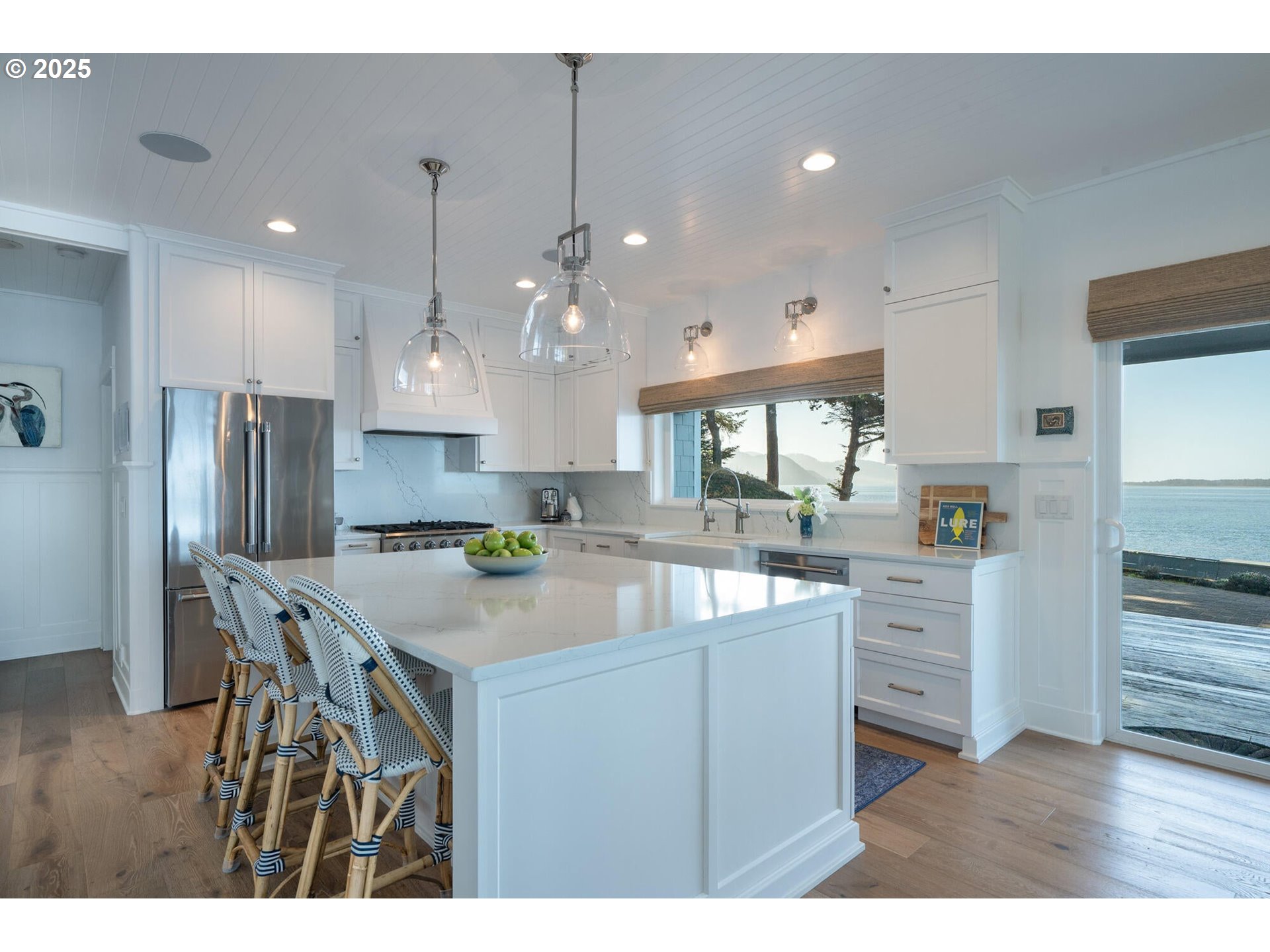 3375 Netarts Bay Drive Netarts, OR 97141 - Photo 13 of 48 a kitchen with kitchen island white cabinets and stainless steel appliances