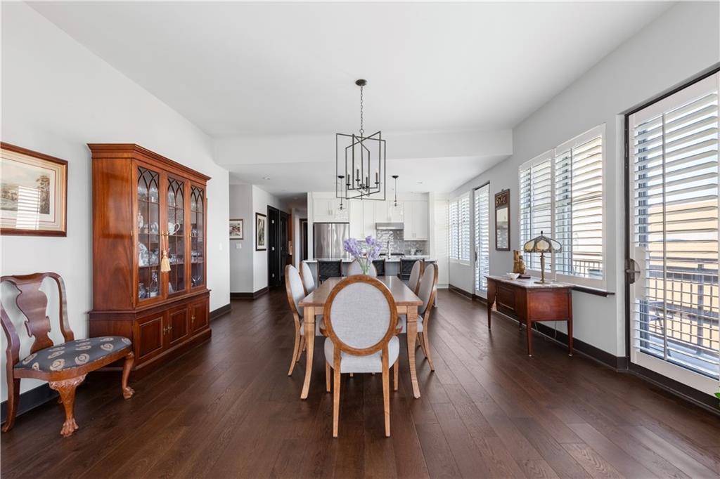 201 West Ponce De Leon Avenue, Unit 502 Decatur, GA 30030 - Photo 11 of 49 a dining room with wooden floor a chandelier a wooden table and chairs