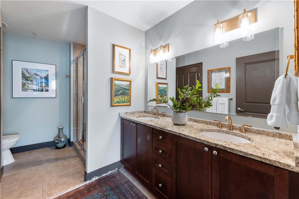 201 West Ponce De Leon Avenue, Unit 502 Decatur, GA 30030 - Photo 22 of 49 a bathroom with a granite countertop double vanity sink and a mirror
