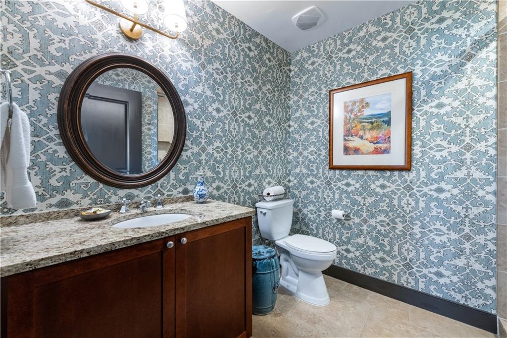 201 West Ponce De Leon Avenue, Unit 502 Decatur, GA 30030 - Photo 27 of 49 a bathroom with a granite countertop toilet and a sink