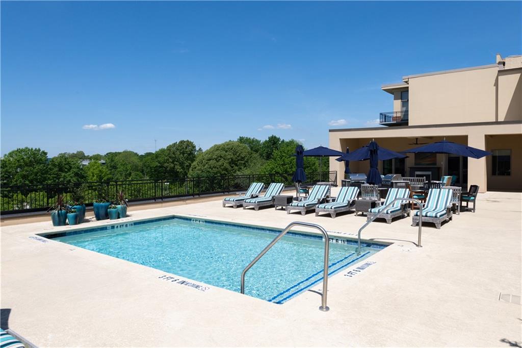 201 West Ponce De Leon Avenue, Unit 502 Decatur, GA 30030 - Photo 39 of 49 a view of a swimming pool with outdoor seating and plants