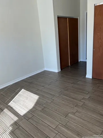 a view of an empty room and wooden floor