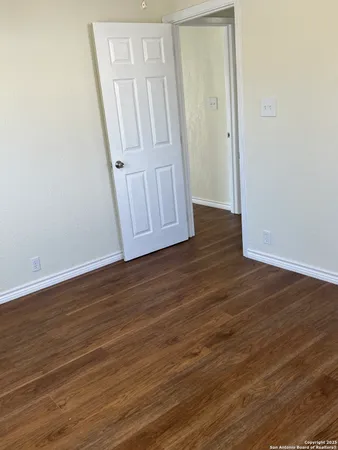 an empty room with wooden floor