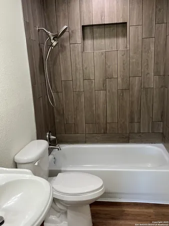 a bathroom with a toilet a sink and bathtub