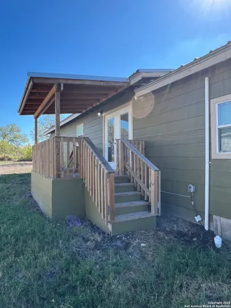 a view of backyard with deck and wooden floor