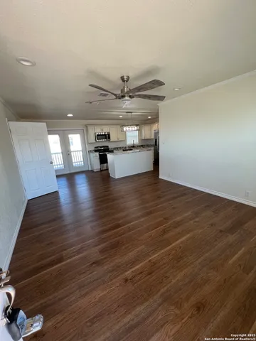 a view of an empty room with wooden floor