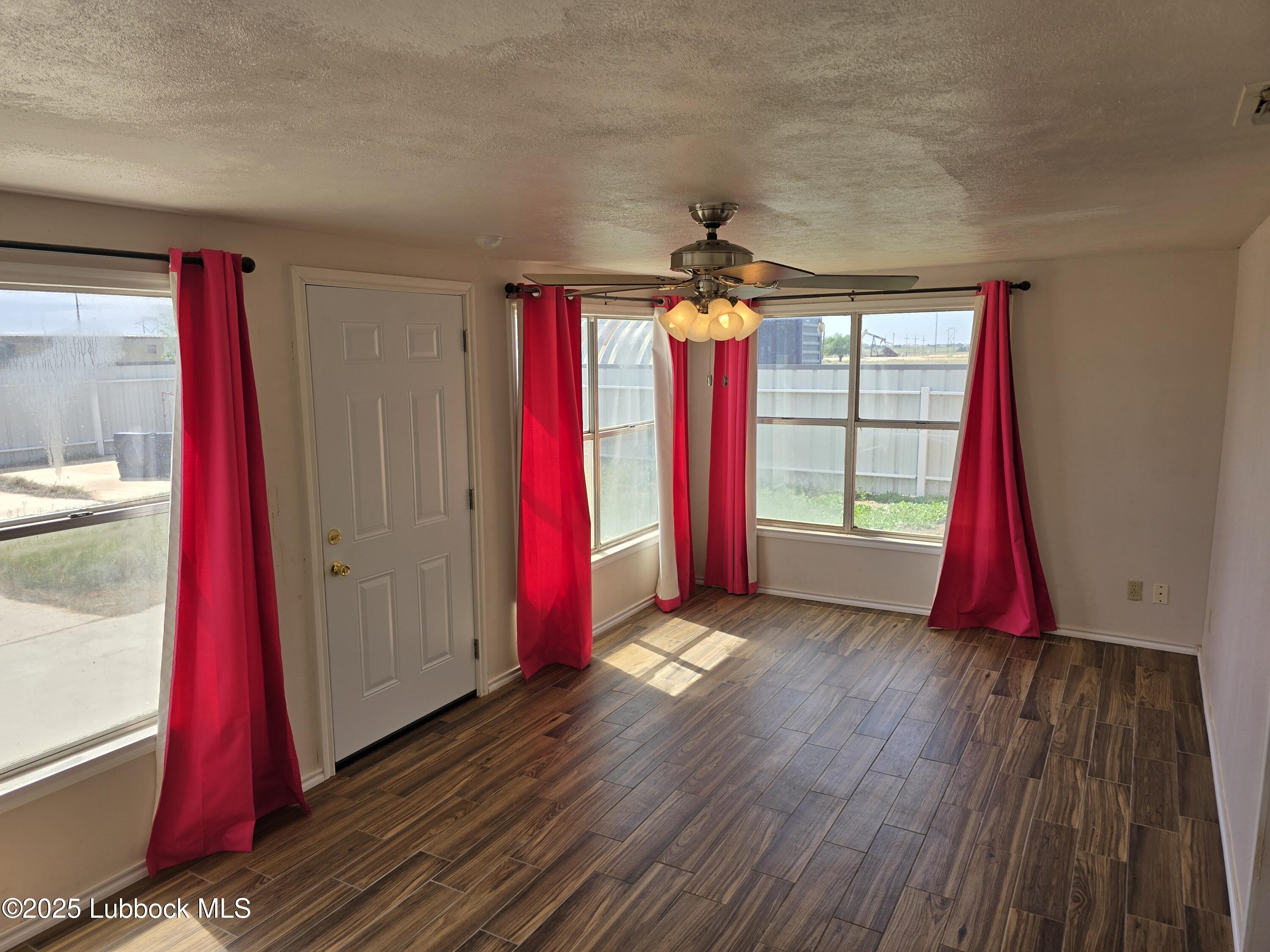 1681 Co Road Denver City, TX 79323 - Photo 12 of 30 a view of a room with a wooden floor and tub