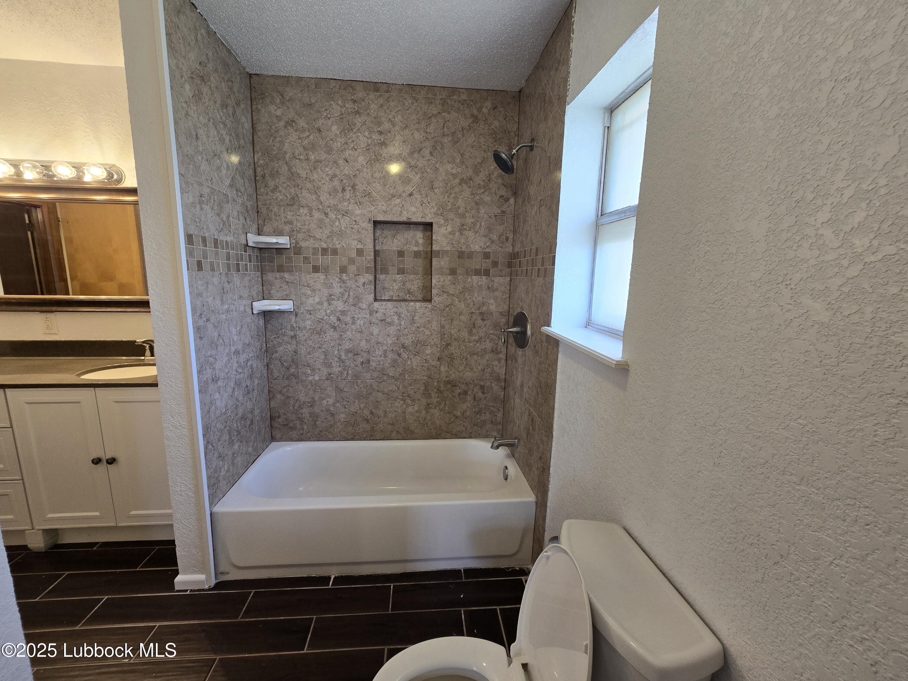 1681 Co Road Denver City, TX 79323 - Photo 15 of 30 a bathroom with a shower and a toilet