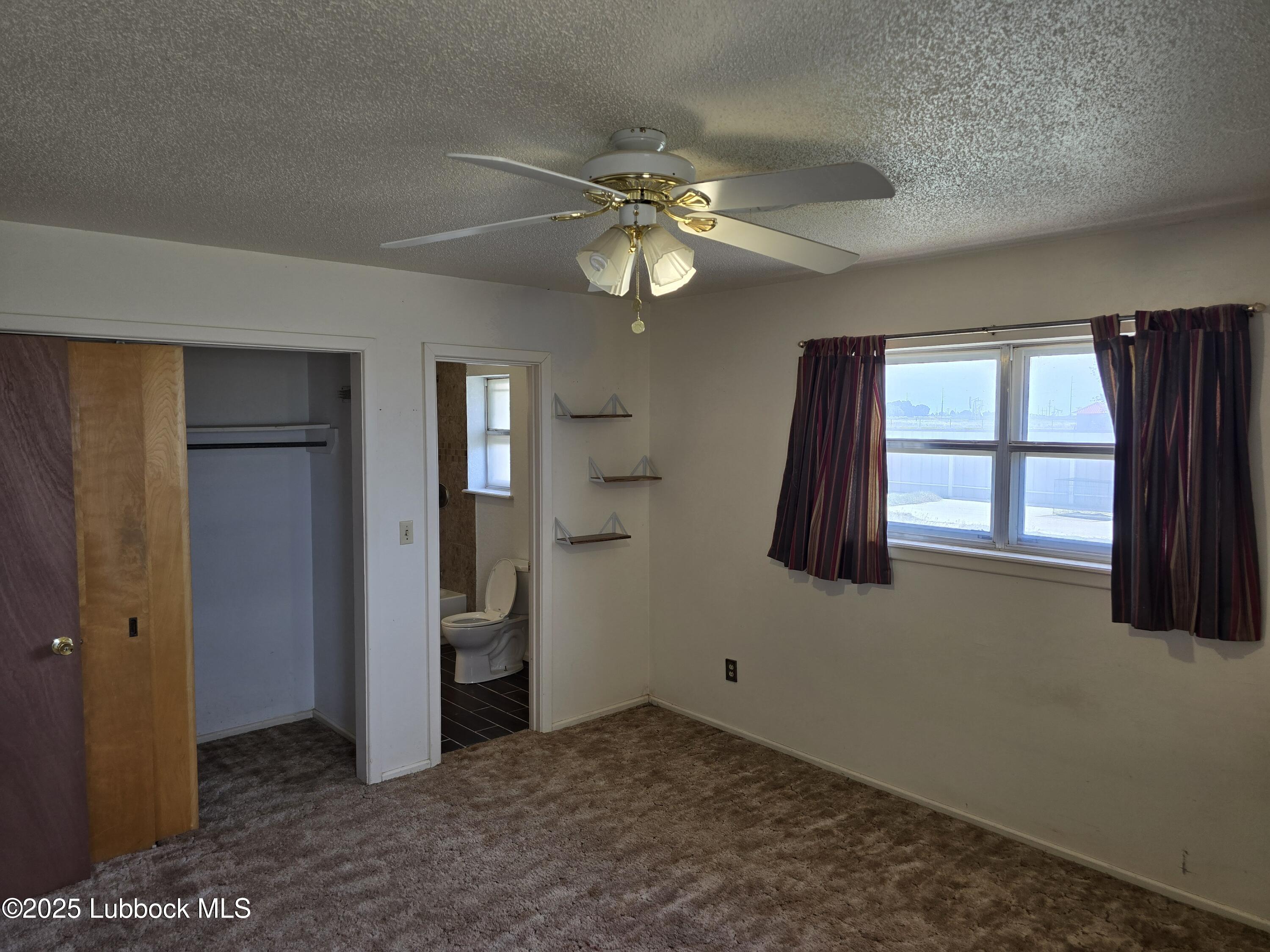 1681 Co Road Denver City, TX 79323 - Photo 18 of 30 wooden floor in an empty room with a window