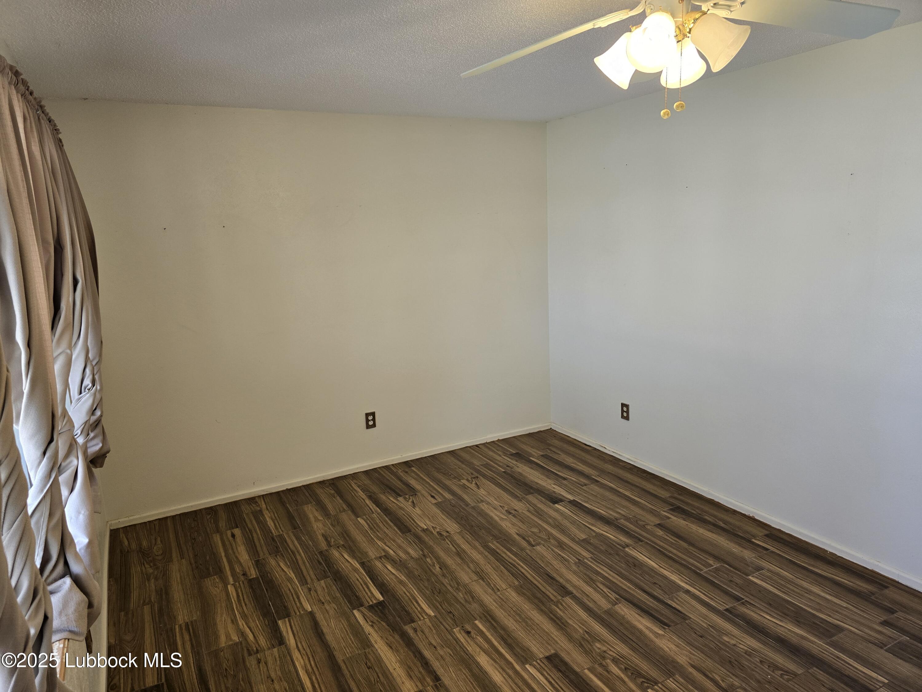 1681 Co Road Denver City, TX 79323 - Photo 4 of 30 a view of a room with wooden floor and a window