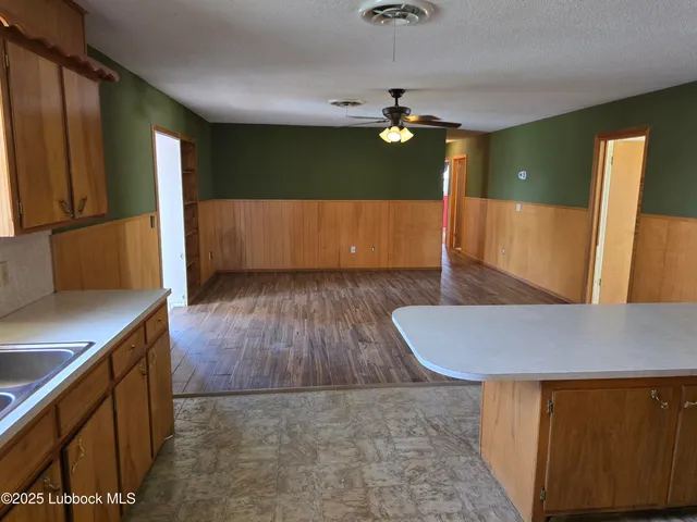 a living room with wooden floor and furniture