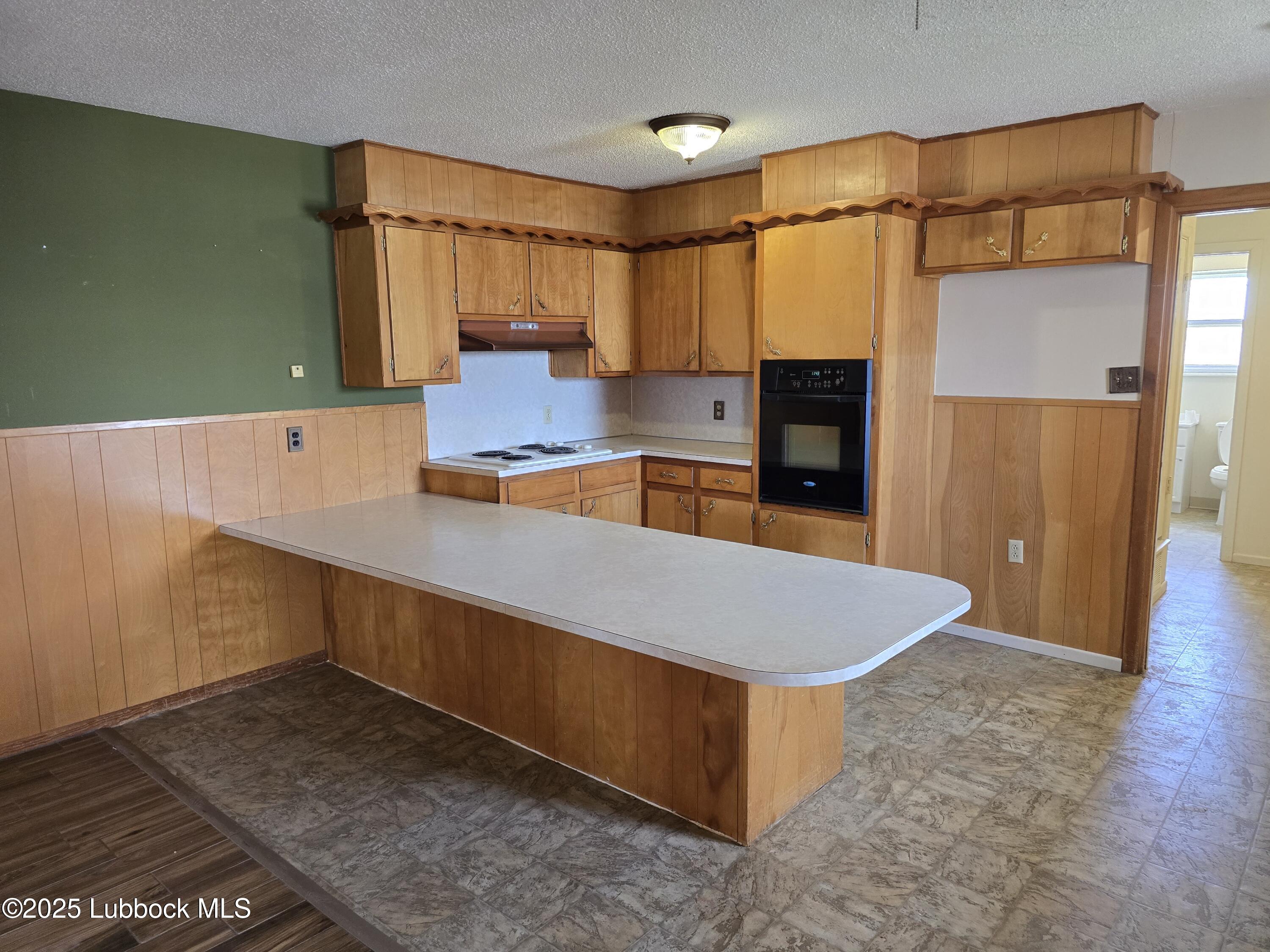 1681 Co Road Denver City, TX 79323 - Photo 8 of 30 a kitchen with stainless steel appliances a refrigerator and a stove